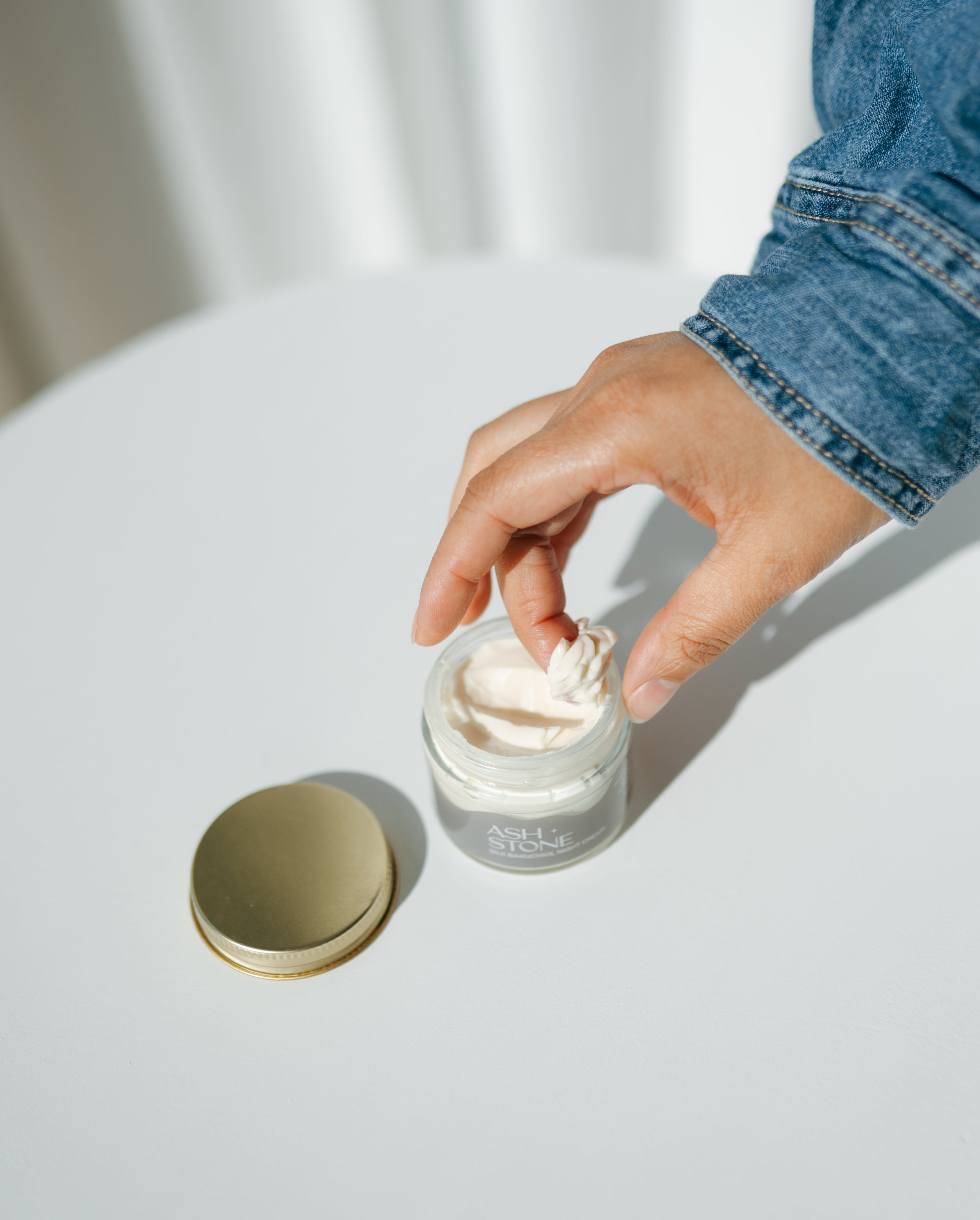 Open jar showing rich bakuchiol and shea butter night cream texture